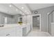 Bright bathroom featuring white cabinets, double sinks, framed mirror, bathtub, glass shower, and tiled flooring at 1570 Woodberry Run Dr, Snellville, GA 30078