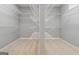 Walk-in closet features white wire shelving and beige carpeting at 1570 Woodberry Run Dr, Snellville, GA 30078