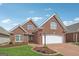Beautiful two-story brick home featuring a brick driveway and an attached two-car garage at 1570 Woodberry Run Dr, Snellville, GA 30078