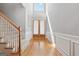 Bright foyer with hardwood floors, detailed wood trim, and a large window above the front door at 1570 Woodberry Run Dr, Snellville, GA 30078