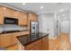 Modern kitchen with wood cabinets, granite countertops, stainless steel appliances, and a center island at 1570 Woodberry Run Dr, Snellville, GA 30078