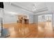 Spacious open-plan living area with hardwood floors, modern lighting, and kitchen island with seating at 1570 Woodberry Run Dr, Snellville, GA 30078