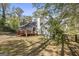 Backyard featuring a deck, grassy area, mature trees, and a well-maintained lawn at 4875 Ben Hill Rd, College Park, GA 30349