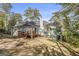 Backyard featuring a deck, grassy area, mature trees, and a well-maintained lawn at 4875 Ben Hill Rd, College Park, GA 30349