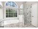 Bright bathroom features a soaking tub and separate glass-enclosed shower at 4875 Ben Hill Rd, College Park, GA 30349