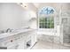 Bright bathroom features double sinks, a soaking tub and separate walk-in shower at 4875 Ben Hill Rd, College Park, GA 30349