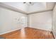 Spacious bedroom features hardwood floors and natural light through the windows at 4875 Ben Hill Rd, College Park, GA 30349