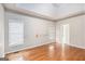 Spacious bedroom features hardwood floors and natural light through the windows at 4875 Ben Hill Rd, College Park, GA 30349