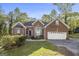 Charming single-story brick home featuring manicured lawn and attached two-car garage at 4875 Ben Hill Rd, College Park, GA 30349