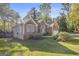 Brick home featuring a well-manicured lawn, mature trees, and an attached garage at 4875 Ben Hill Rd, College Park, GA 30349