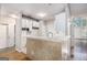 Bright kitchen featuring white cabinets, bar seating, and stainless steel sink at 4875 Ben Hill Rd, College Park, GA 30349
