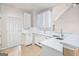 Bright kitchen boasts stainless steel sink, white cabinets and a tile backsplash at 4875 Ben Hill Rd, College Park, GA 30349
