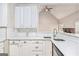 Bright kitchen boasts stainless steel sink, white cabinets and a tile backsplash at 4875 Ben Hill Rd, College Park, GA 30349