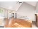 Spacious living room featuring hardwood floors, vaulted ceilings, neutral paint, and access to other rooms at 4875 Ben Hill Rd, College Park, GA 30349