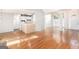 Open-concept living space with hardwood floors seamlessly connecting living room and kitchen area at 4875 Ben Hill Rd, College Park, GA 30349