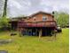 Exterior back view of a brick house with a large deck at 6501 River Run Rd, Riverdale, GA 30274