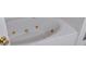 A luxurious white bathtub with gold fixtures offering a relaxing spa-like experience at 6501 River Run Rd, Riverdale, GA 30274