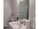 Bathroom with large mirror, white countertop, and toilet at 6501 River Run Rd, Riverdale, GA 30274