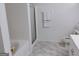 Clean bathroom with a glass-enclosed shower, modern vanity, and stylish marble floors at 6501 River Run Rd, Riverdale, GA 30274