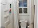 Bathroom with a combined shower-tub and unique window, offering natural light at 6501 River Run Rd, Riverdale, GA 30274