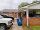 Covered parking with brick columns and view of front door and car port at 6501 River Run Rd, Riverdale, GA 30274