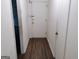Entrance hall with laminate wood flooring, and a white door at 6501 River Run Rd, Riverdale, GA 30274