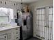 View of stainless steel refrigerator, sink, and backdoor with window at 6501 River Run Rd, Riverdale, GA 30274