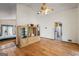 Open living room with hardwood floors, cabinet, ceiling fan, and kitchen view at 655 Sunset Dr, Locust Grove, GA 30248