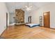 Spacious living room with hardwood floors, stone fireplace and ample natural light at 655 Sunset Dr, Locust Grove, GA 30248