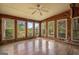 Sun room with wood paneled walls and floors, plus multiple large windows at 655 Sunset Dr, Locust Grove, GA 30248