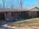 Charming single story brick home with red shutters and mature trees at 1667 Park Pl, Lithia Springs, GA 30122