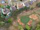 Aerial view showcasing the home's location within a golf course community, highlighting neighborhood layout and landscaping at 5297 Heron Bay Blvd, Locust Grove, GA 30248