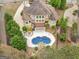 Aerial view of the backyard showcasing the pool with waterfall feature, deck, patio and spiral staircase at 5297 Heron Bay Blvd, Locust Grove, GA 30248