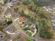 Aerial view of a home nestled within a well-manicured neighborhood, backing onto a picturesque golf course at 5297 Heron Bay Blvd, Locust Grove, GA 30248