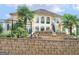 Expansive backyard with lush landscaping, a unique dolphin statue, and a multi-level retaining wall at 5297 Heron Bay Blvd, Locust Grove, GA 30248