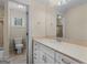 Traditional bathroom features a vanity with drawers, large mirror, and a combined shower-tub with glass door at 5297 Heron Bay Blvd, Locust Grove, GA 30248