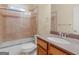 Well-lit bathroom featuring a vanity, granite countertop, and tub-shower with glass doors at 5297 Heron Bay Blvd, Locust Grove, GA 30248