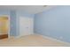 Light blue bedroom with white trim and closet doors, perfect for storage at 5297 Heron Bay Blvd, Locust Grove, GA 30248