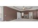 Inviting bedroom with a fireplace, tray ceilings, and access to an en-suite bathroom at 5297 Heron Bay Blvd, Locust Grove, GA 30248