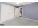 Inviting bedroom features plush carpet, neutral colors, closet and ensuite bathroom with ample natural light at 5297 Heron Bay Blvd, Locust Grove, GA 30248