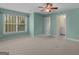 Bright bedroom with neutral carpet, a large window, and a convenient en suite bathroom at 5297 Heron Bay Blvd, Locust Grove, GA 30248