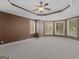 Spacious bedroom with plush carpeting, tray ceilings, and bay windows offering natural light at 5297 Heron Bay Blvd, Locust Grove, GA 30248