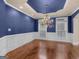 Refined dining room with hardwood floors, blue walls, and a decorative chandelier and trim at 5297 Heron Bay Blvd, Locust Grove, GA 30248
