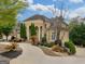 Beautiful home showcasing manicured lawns, a circular driveway, and an attached two car garage at 5297 Heron Bay Blvd, Locust Grove, GA 30248