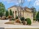 Stately home boasting a circular driveway, lush landscaping, and an attached three car garage at 5297 Heron Bay Blvd, Locust Grove, GA 30248