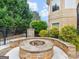 Outdoor firepit made of stone and landscaping, perfect for relaxing and entertaining at 5297 Heron Bay Blvd, Locust Grove, GA 30248