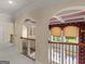 Hallway boasts detailed arches, with coffered ceiling, wrought iron railing, and carpeted floors at 5297 Heron Bay Blvd, Locust Grove, GA 30248