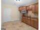 Cozy kitchenette featuring wooden cabinets, countertop, sink and stainless steel microwave at 5297 Heron Bay Blvd, Locust Grove, GA 30248