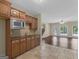 Adjacent kitchenette with tiled floor, wood cabinets, and view to backyard area at 5297 Heron Bay Blvd, Locust Grove, GA 30248