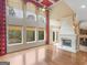 Bright living room featuring large windows, hardwood floors, fireplace, and a ceiling fan at 5297 Heron Bay Blvd, Locust Grove, GA 30248